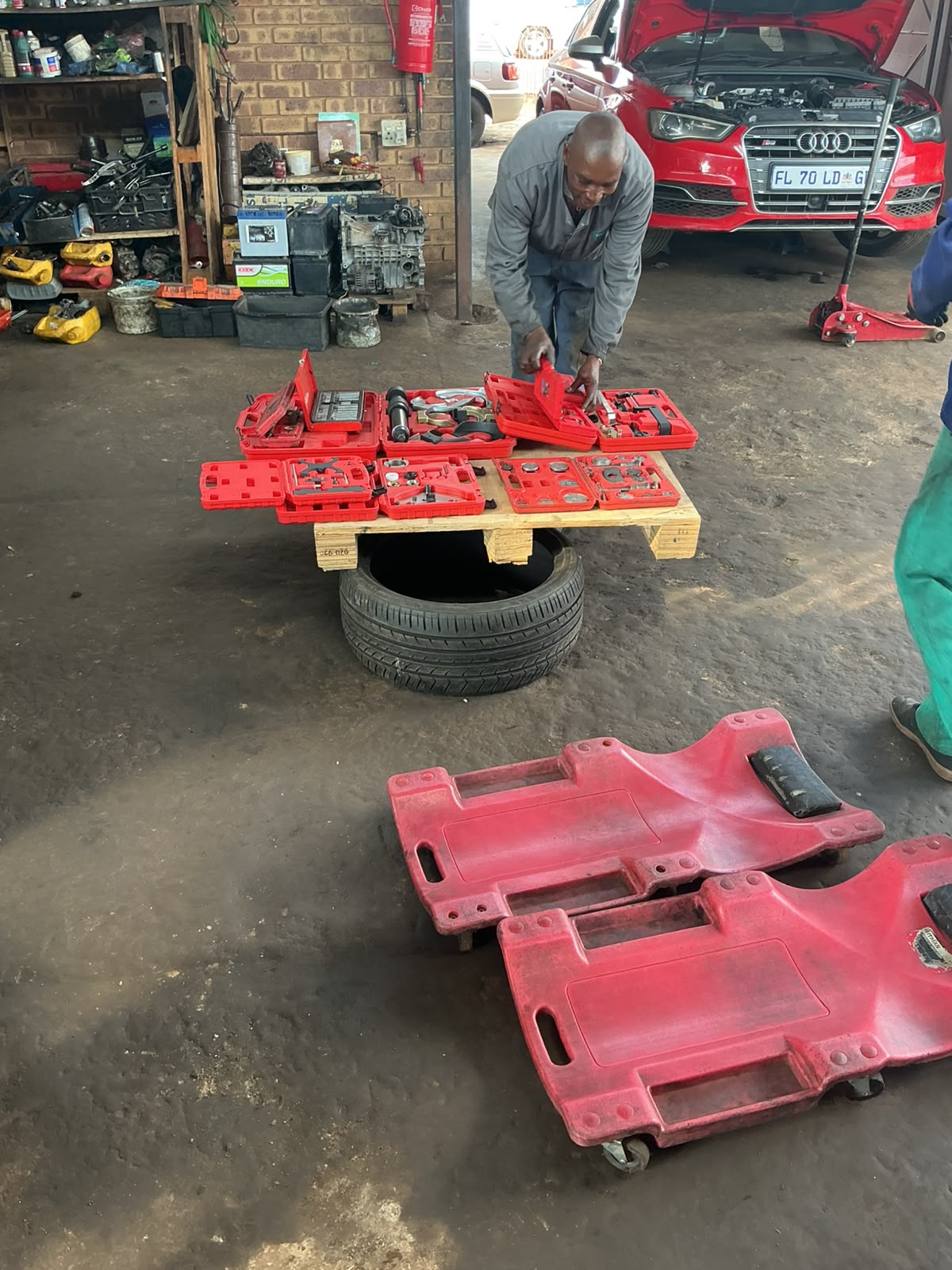 Professional car mechanic working on engine